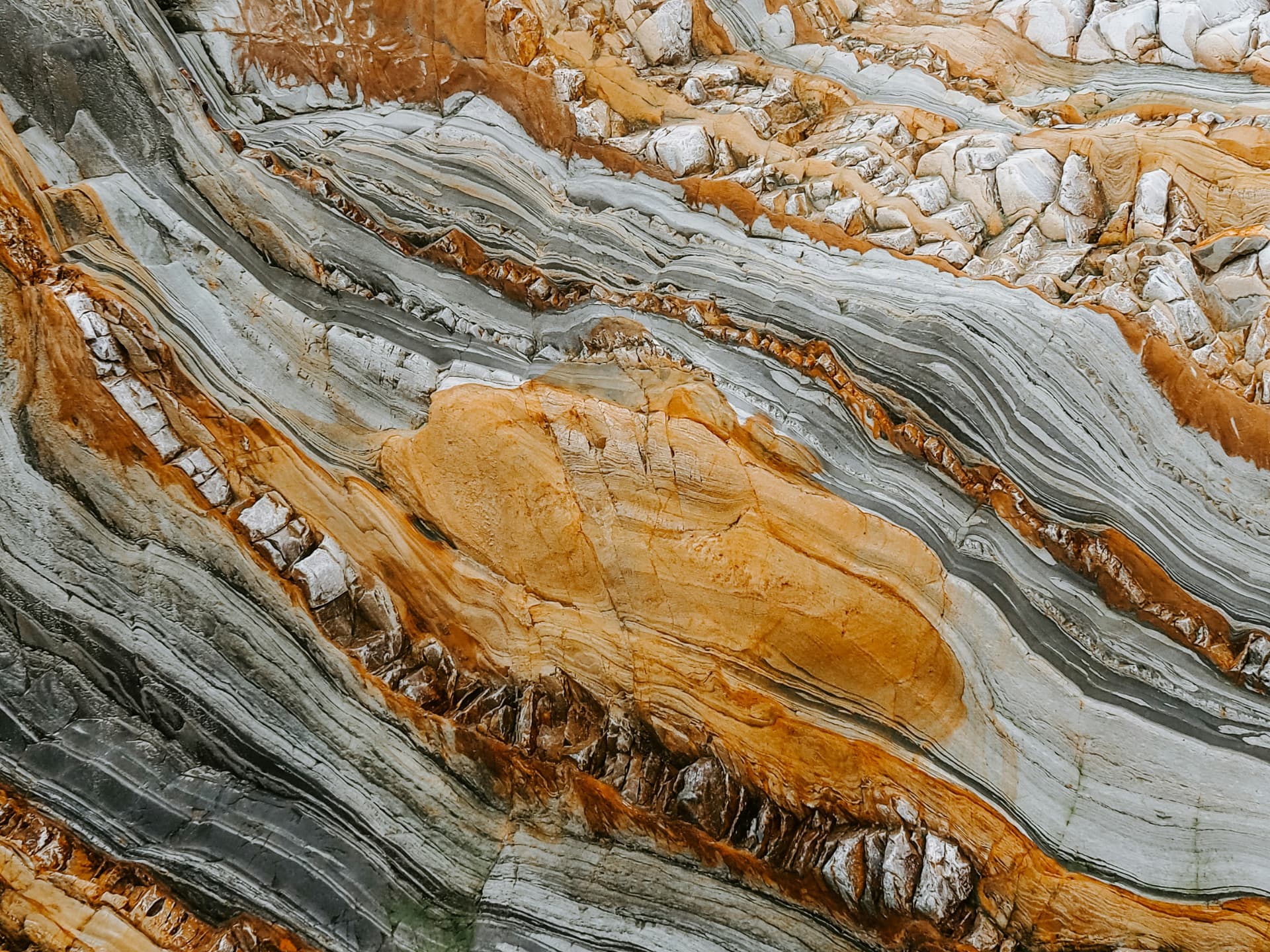 Layered orange and grey rock strata