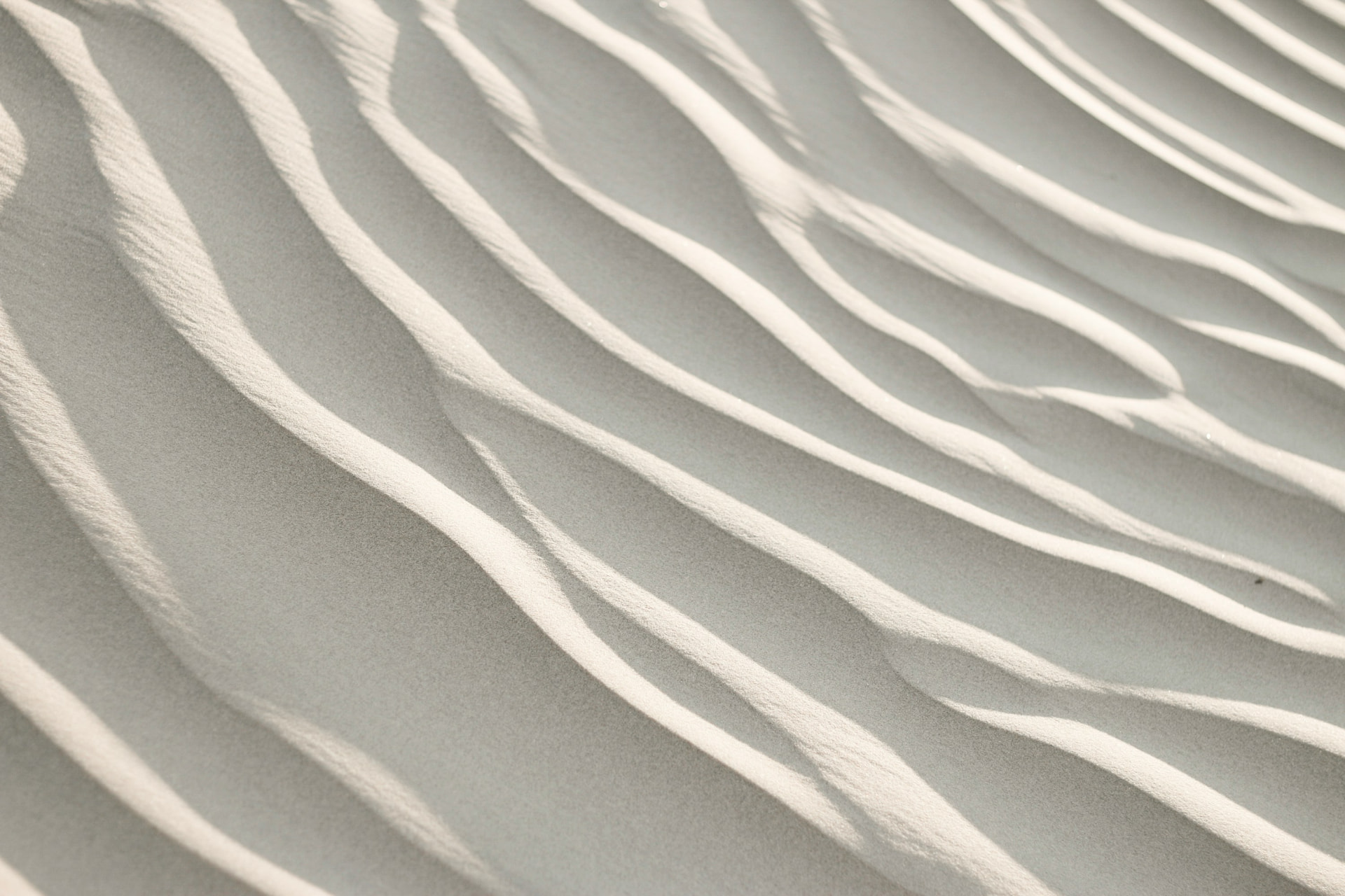 Light cream-colored sand ripples in a circular crop